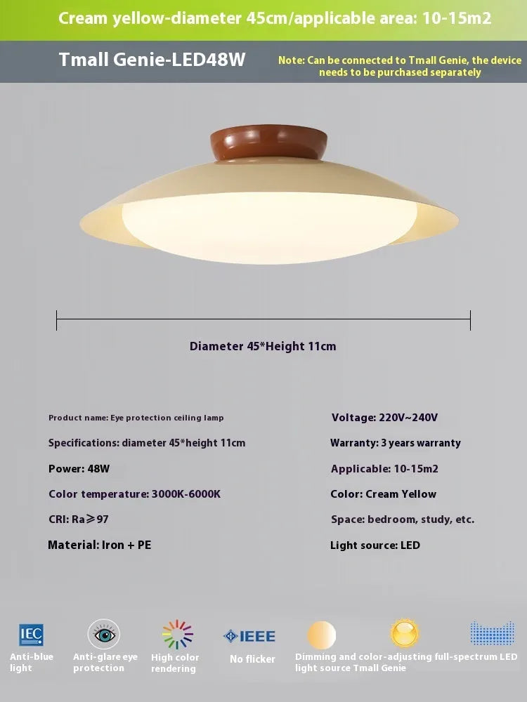 Modern cream-style flying saucer shaped ceiling lamp in a bedroom setting.