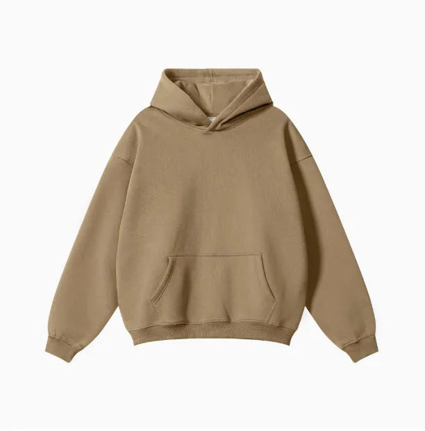 Man wearing a loose-fit grey cotton hooded sweater with drop-shoulder sleeves.