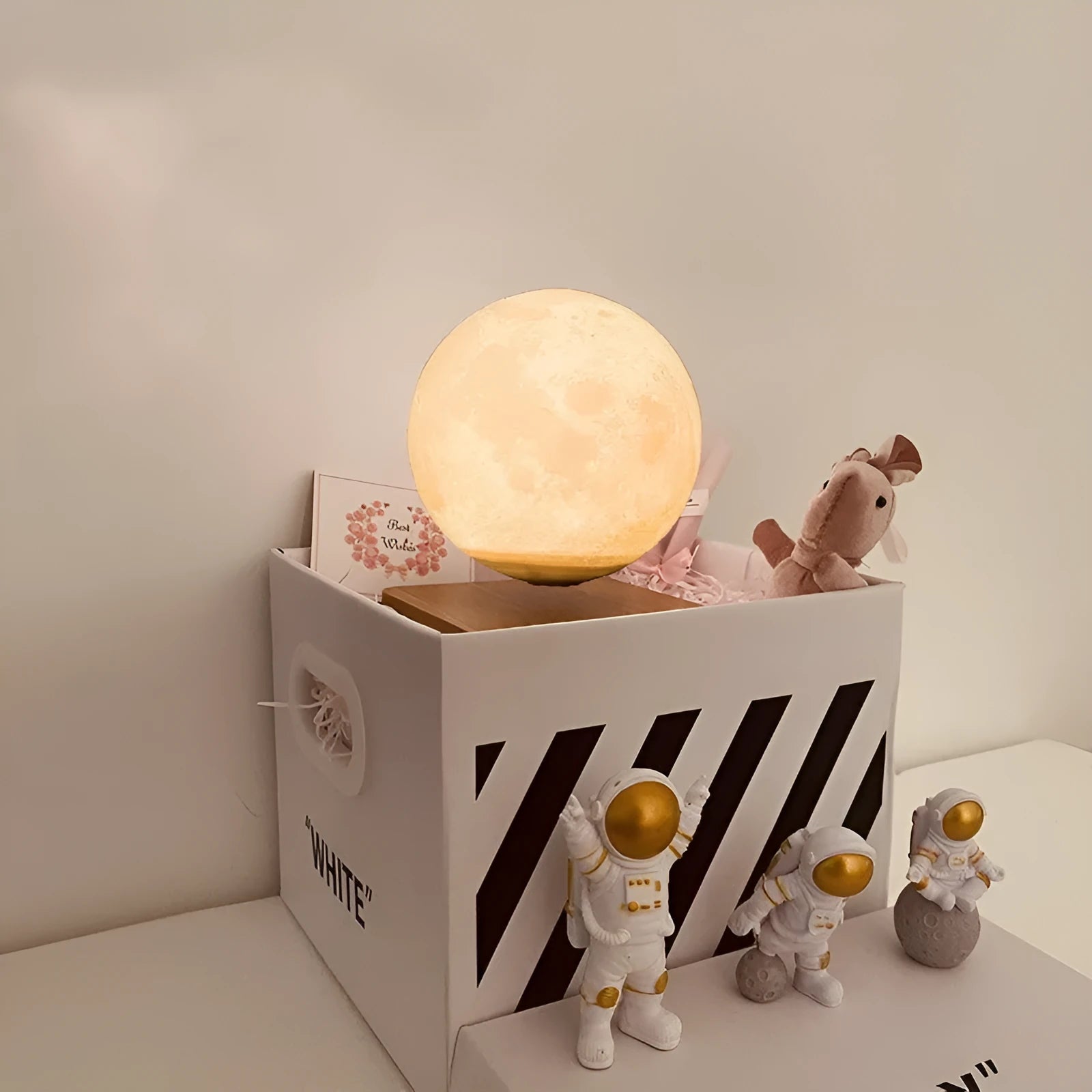 Maglev floating planet night light with LED glow, astronaut figurines, and USB cable.