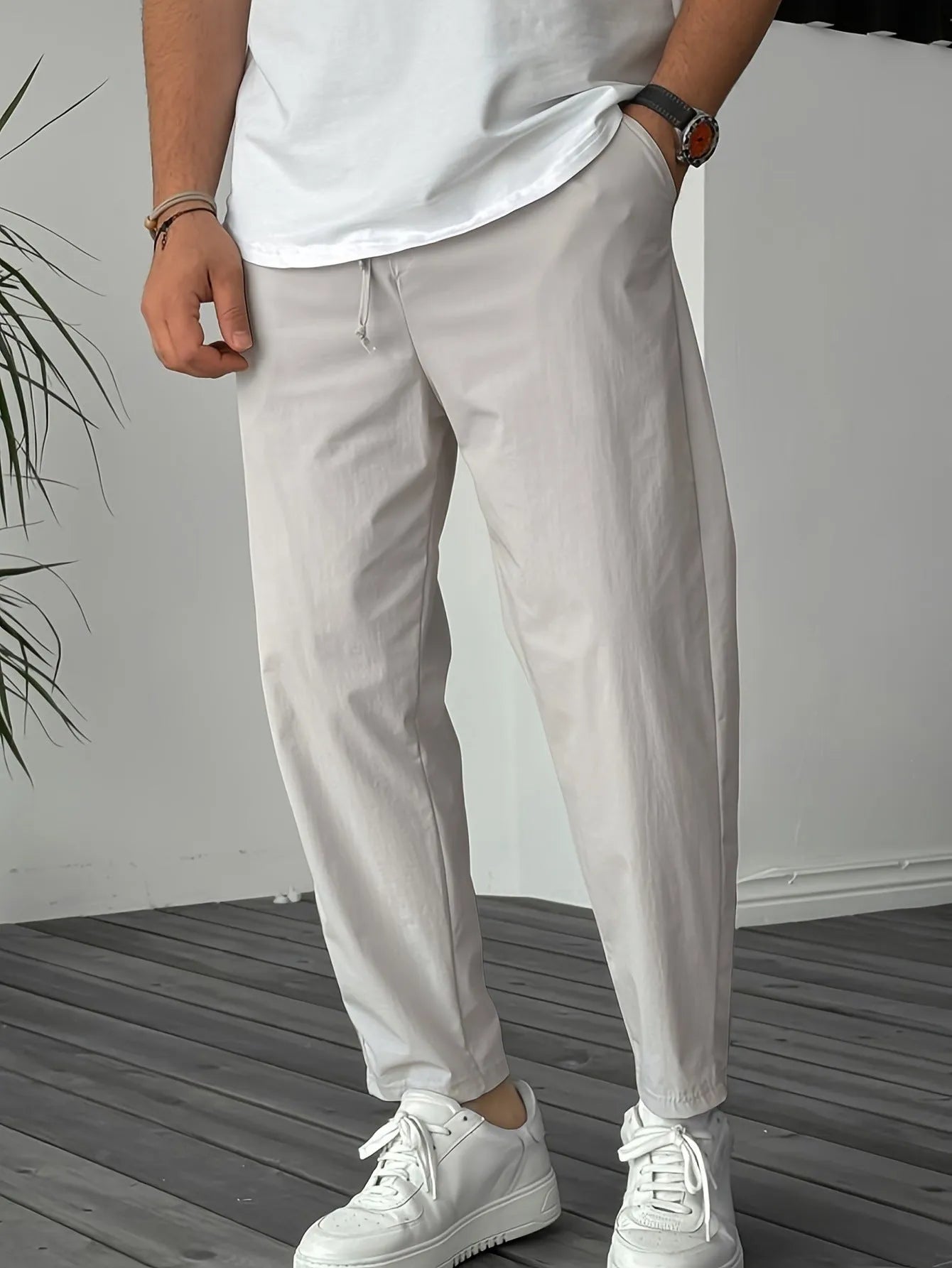 Men's khaki straight-leg drawstring casual trousers with a ribbon pocket detail.