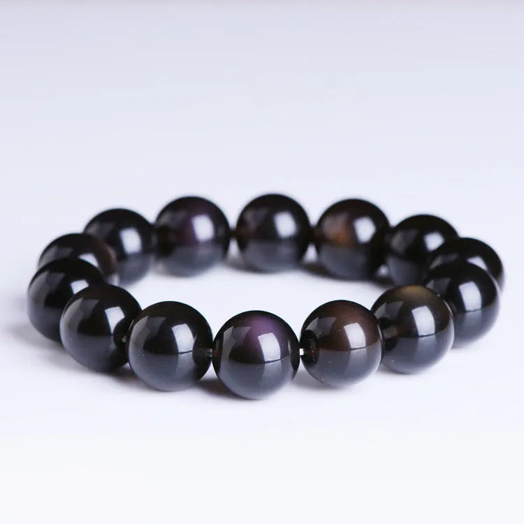 Polished natural crystal Pi Xiu bracelet with geometric beads on a wrist.