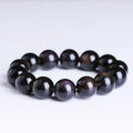 Polished natural crystal Pi Xiu bracelet with geometric beads on a wrist.
