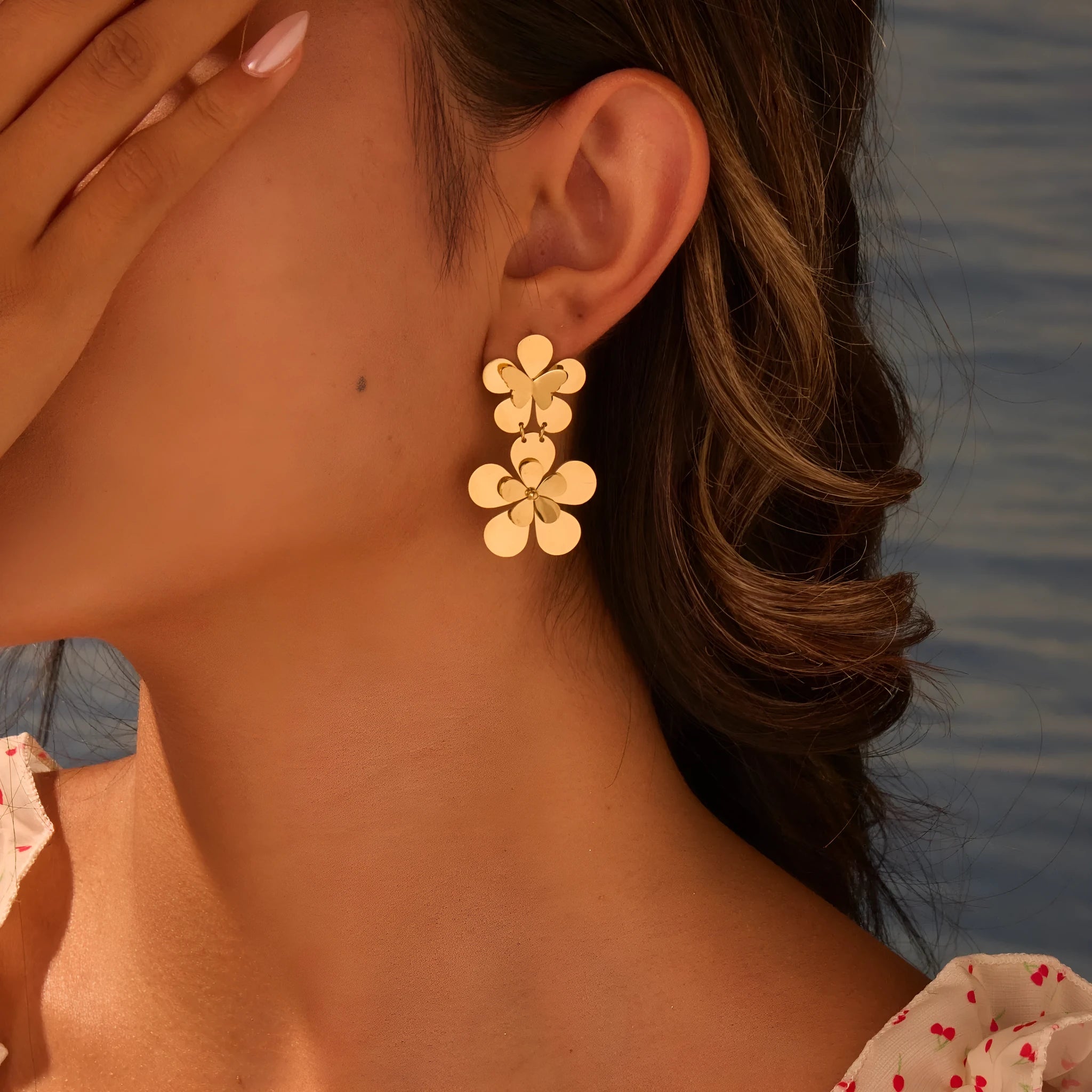 Women's stainless steel earrings with 18K gold electroplated finish featuring floral butterfly and geometric zodiac design