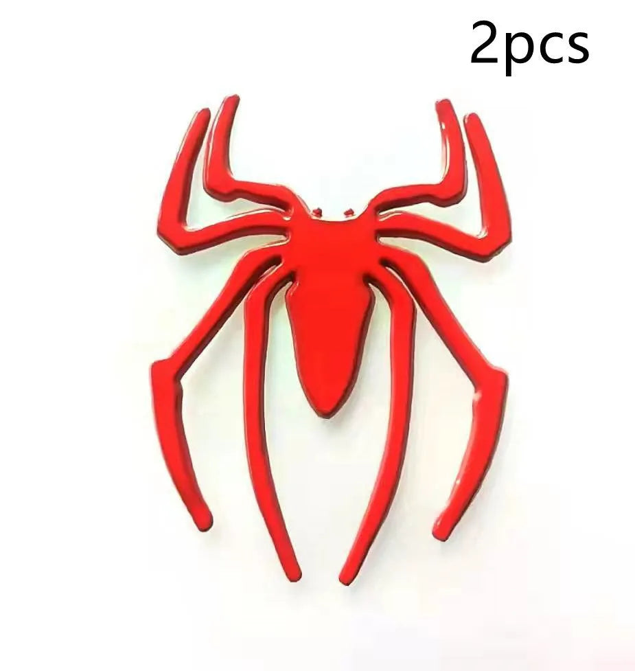 Three-dimensional metal spider bumper sticker in zinc alloy, shown in gold colour.