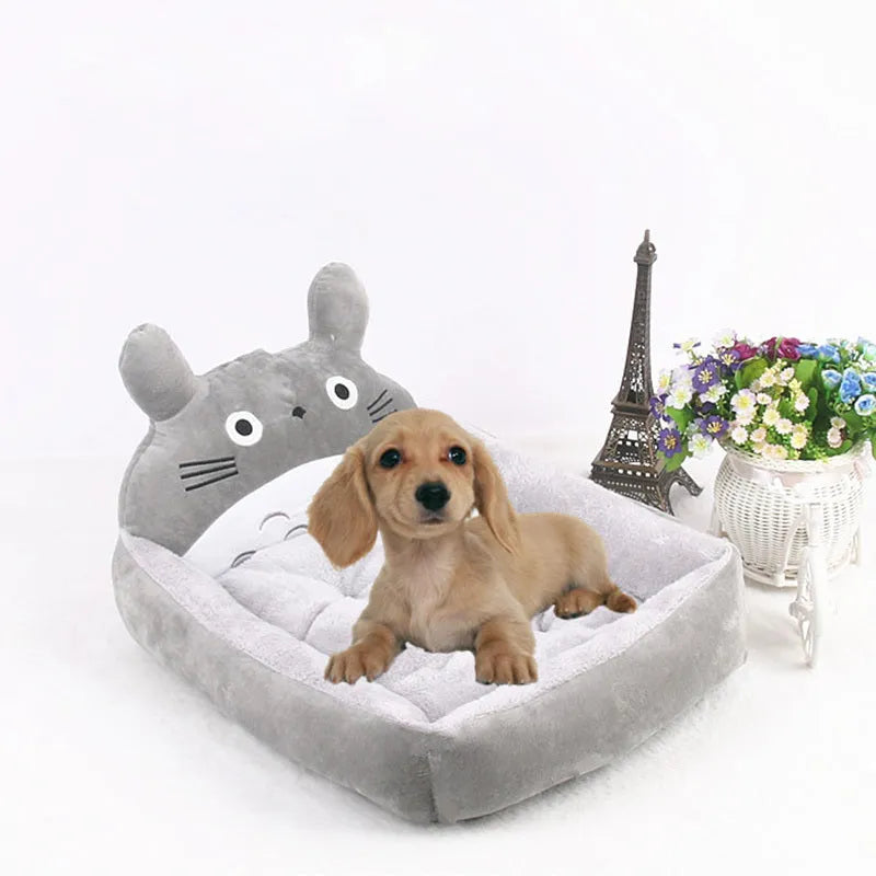 Blue cartoon-style sofa pet bed with a removable padded cushion for a small dog or cat.