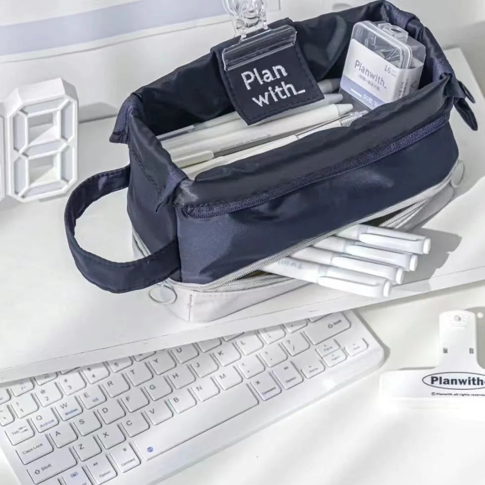 Dark blue folding double-layer polyester pencil case for pens and stationery, shown open to reveal two compartments.