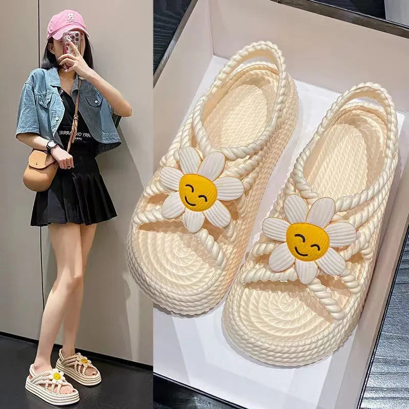Beige women's flat sandals with a three-flower decoration and a non-slip PVC sole.