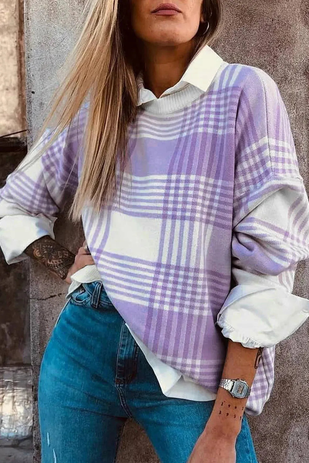 Lilac plaid print loose sweater with ribbed cuffs and hem on a hanger