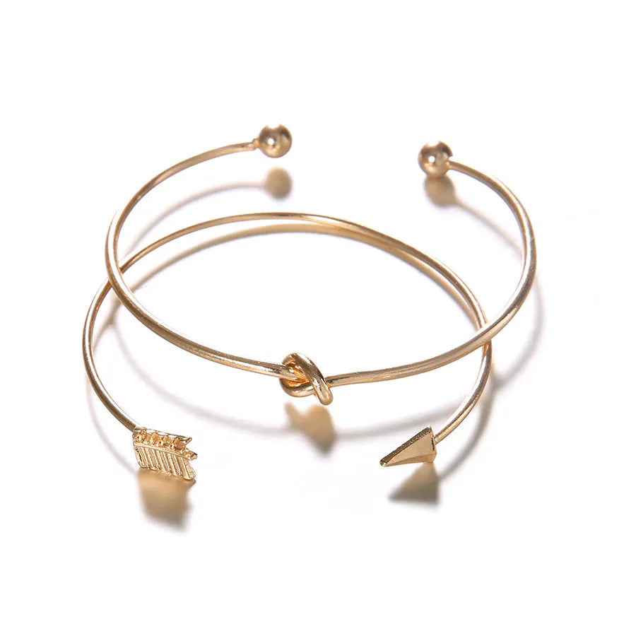 Women's vintage cuff bracelet with arrow knot design in gold electroplated alloy