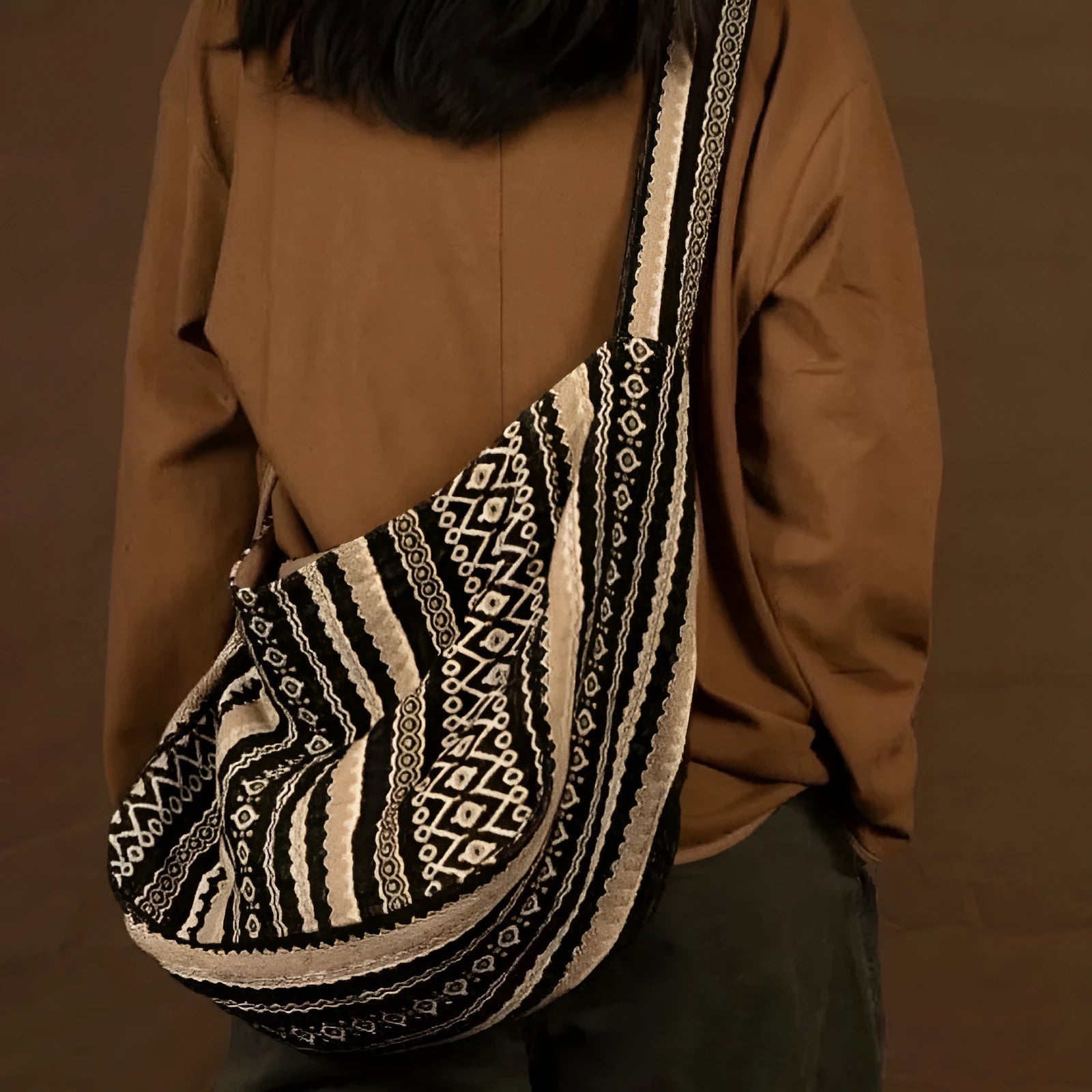 Corduroy vintage messenger bag with jacquard stripes, handprint detail, and an adjustable plaid shoulder strap.