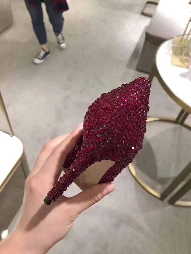 Gold women's pointed toe stiletto high heels with rhinestone and sequin decoration on a shallow-mouth, low-top upper.
