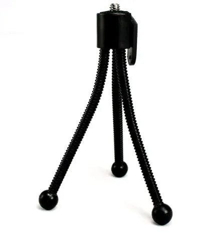 Small silver iron mini tripod with ball head, shown folded next to an iPhone for scale.