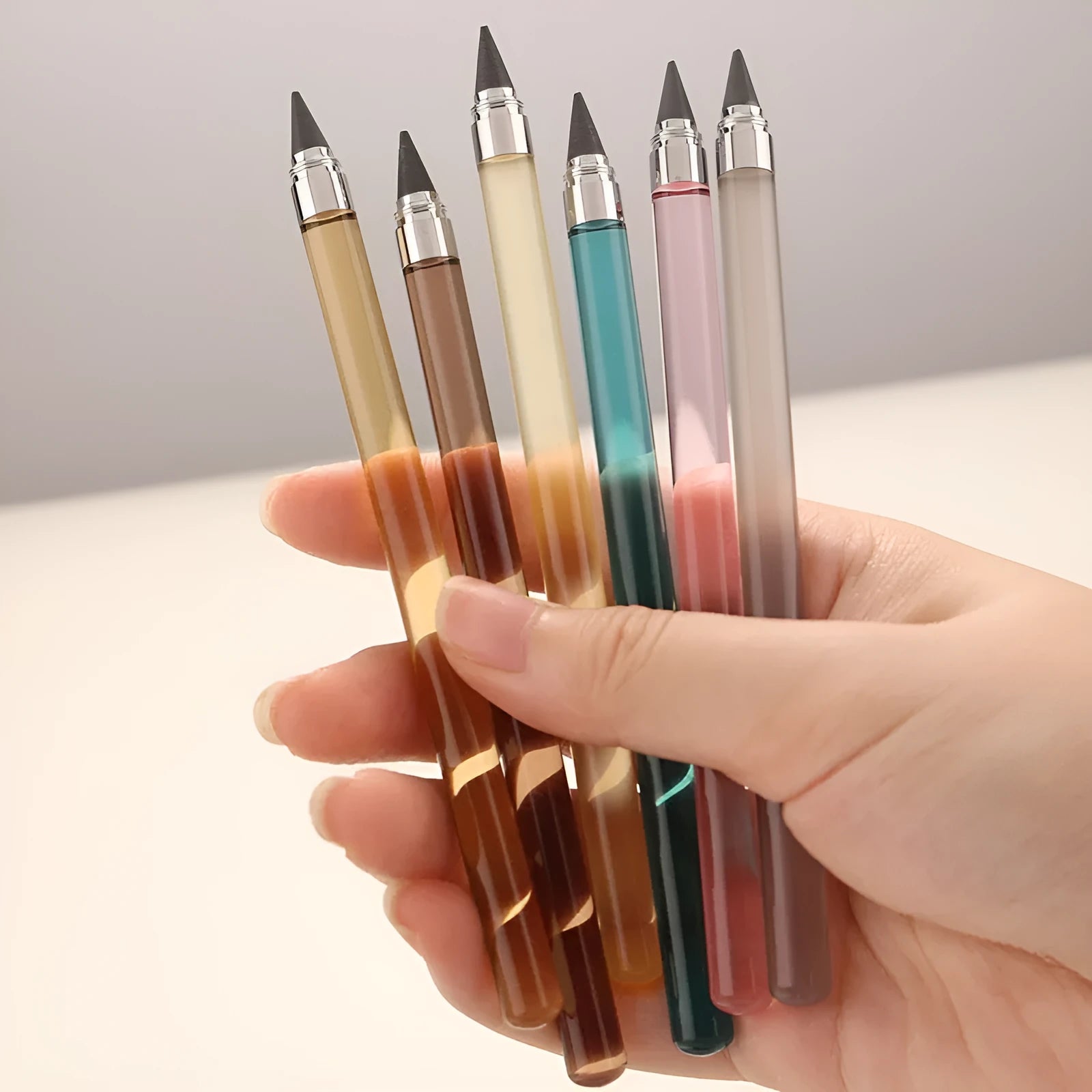 Clear acrylic eternal pencil with alloy pen head showing internal mechanism and colour refill options