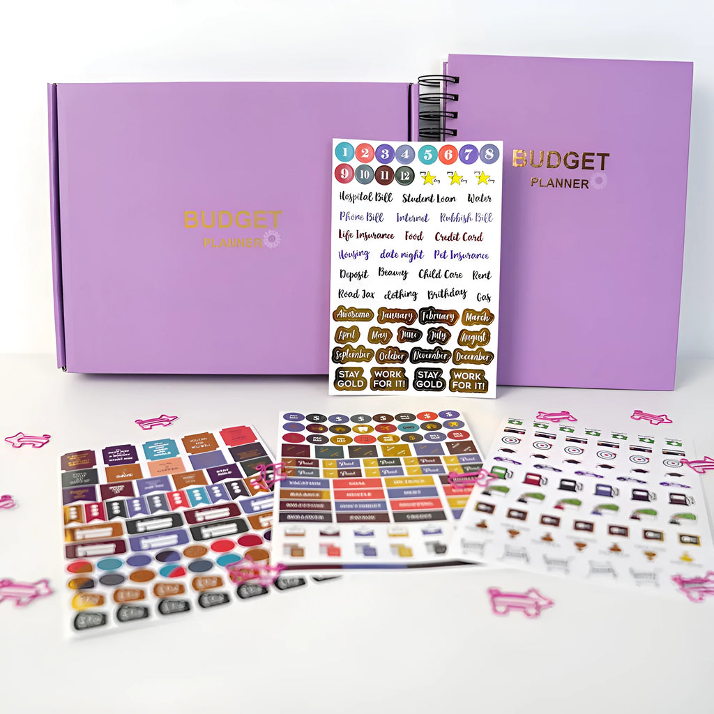 Purple coil-bound financial planning notebook with budget stickers and paper clips