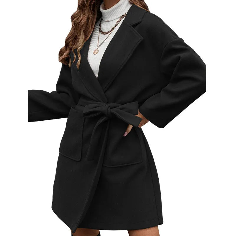 Minimalist loose fit long sleeve coat with lapel buttons and a split belt in a light blue colour.