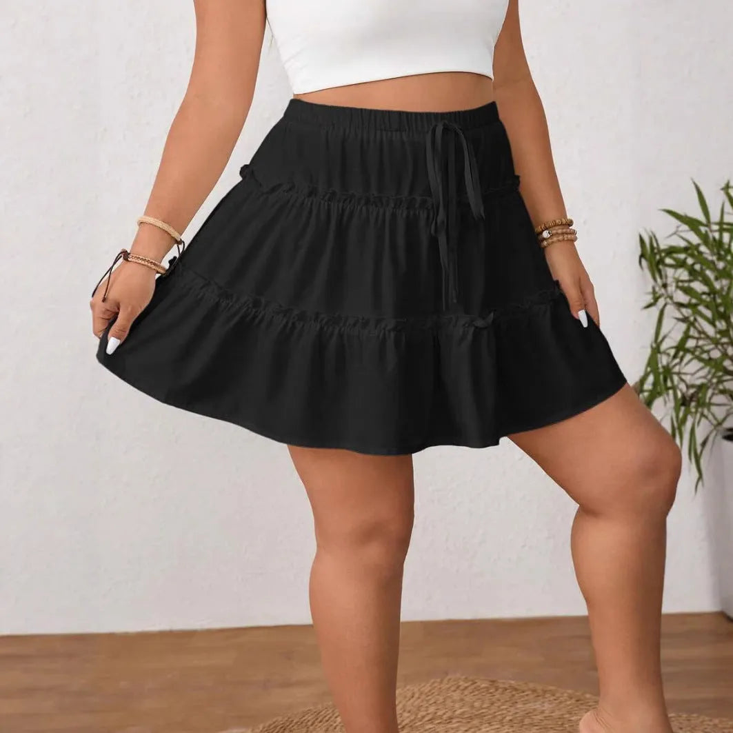 White pleated A-line skirt with lace-up adjustment detail on mannequin