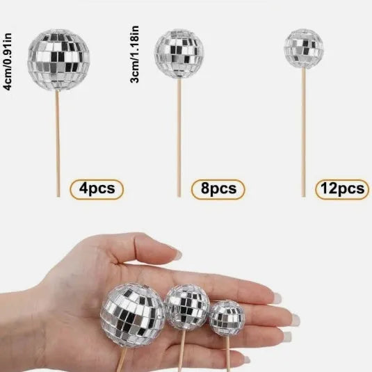Glass disco ball cake decoration on a wooden stick, shown in different sizes.