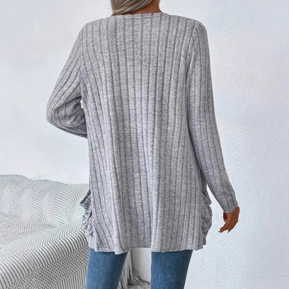 Solid colour long sleeve cardigan with front pockets in a loose fit, shown in grey.