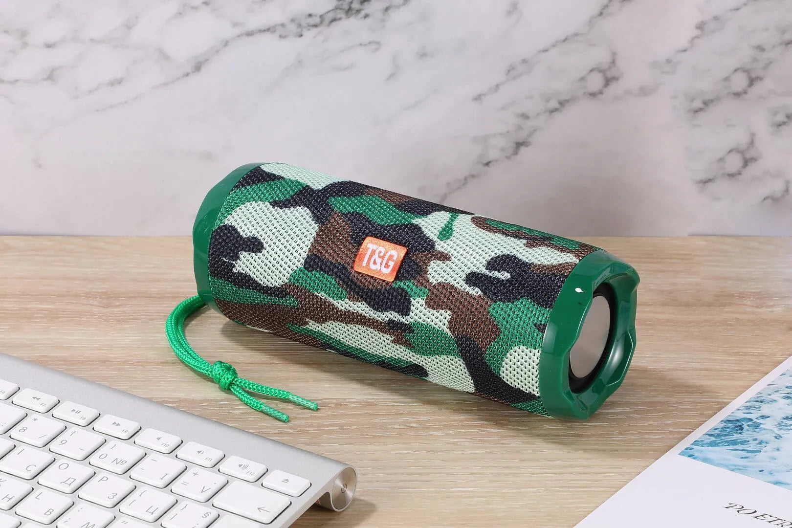 Fabric-covered portable Bluetooth speaker in multiple colours showing card holder slot.