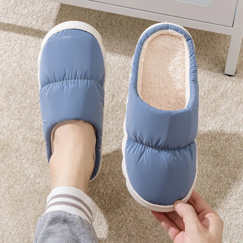 Blue winter slippers with artificial leather upper and thick rubber sole, showing plush lining.