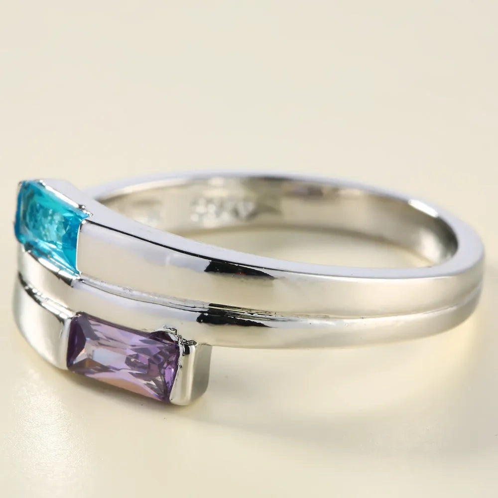 Silver-coloured copper ring with a zircon stone inlay, shown in ins style.