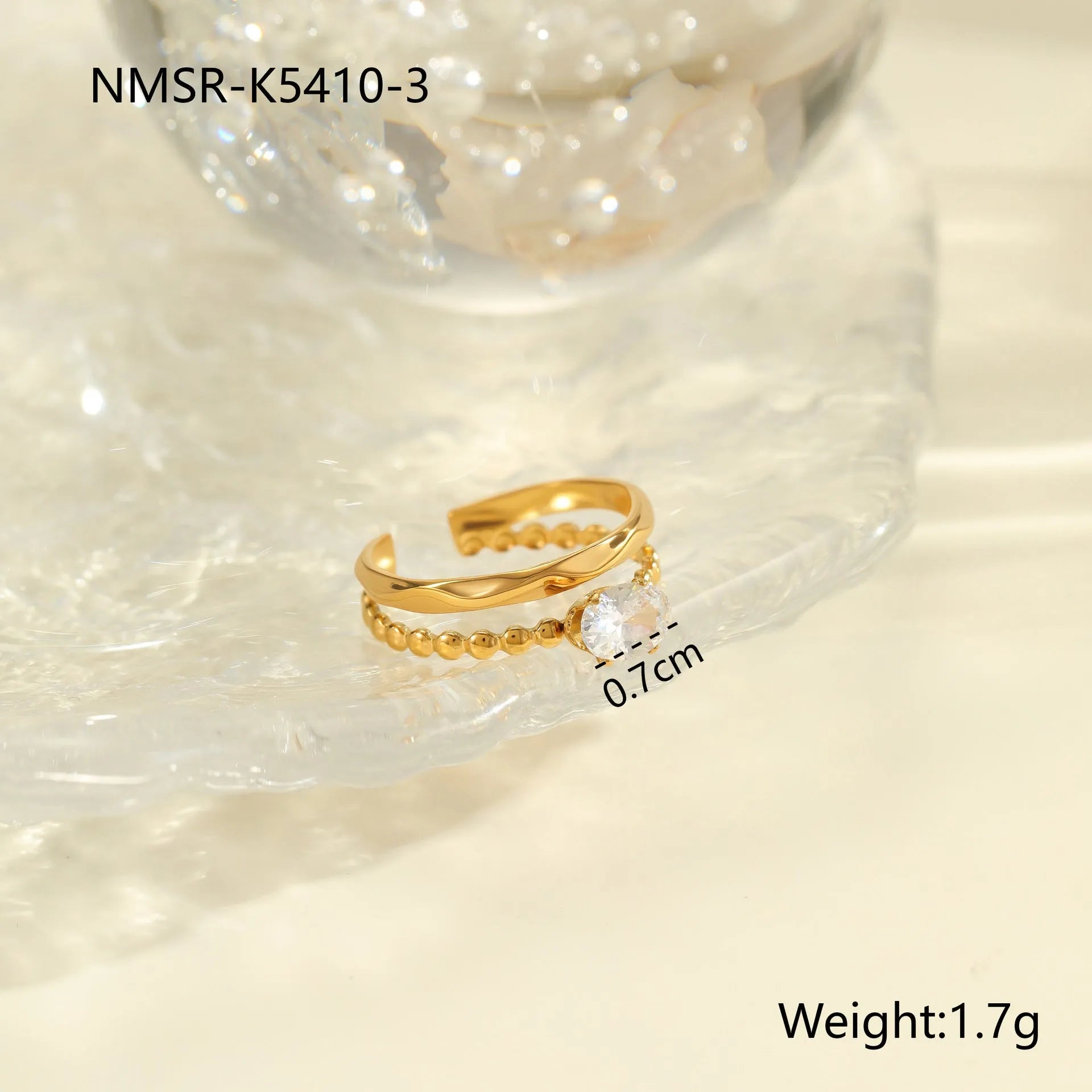 Gold inlaid zircon geometric heart and drop shape stainless steel ring on white background.