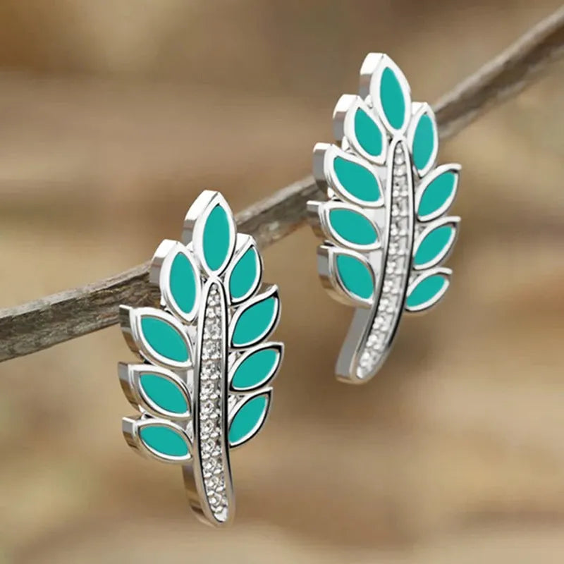 Pair of leaf-shaped copper stud earrings with white gold colour finish and inlaid zircon stone