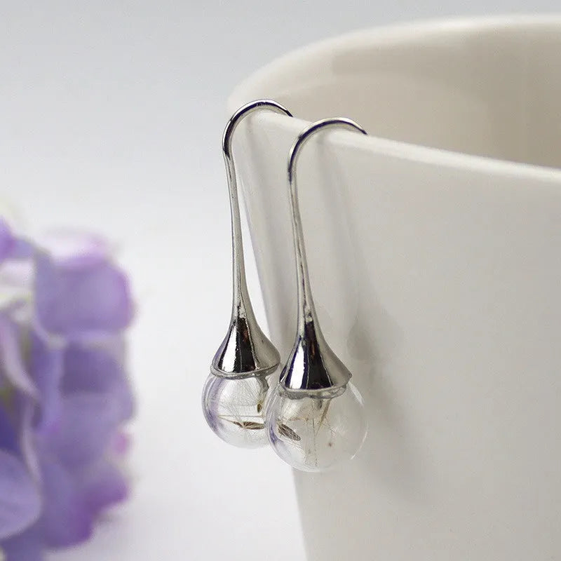 Transparent glass ball earrings with dandelion seed crystal design in silver and bronze finishes