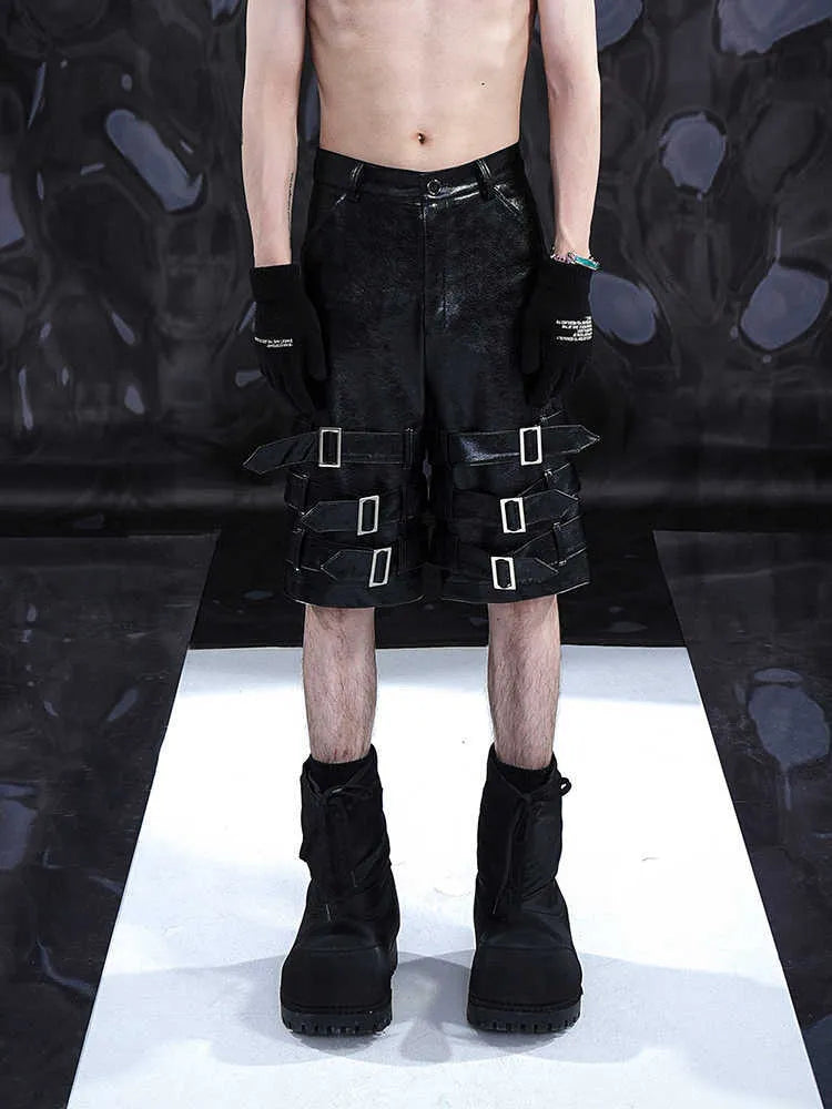Men's black PU leather cropped shorts on a neutral background