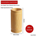 Wild bamboo chopsticks holder tube on a kitchen countertop.
