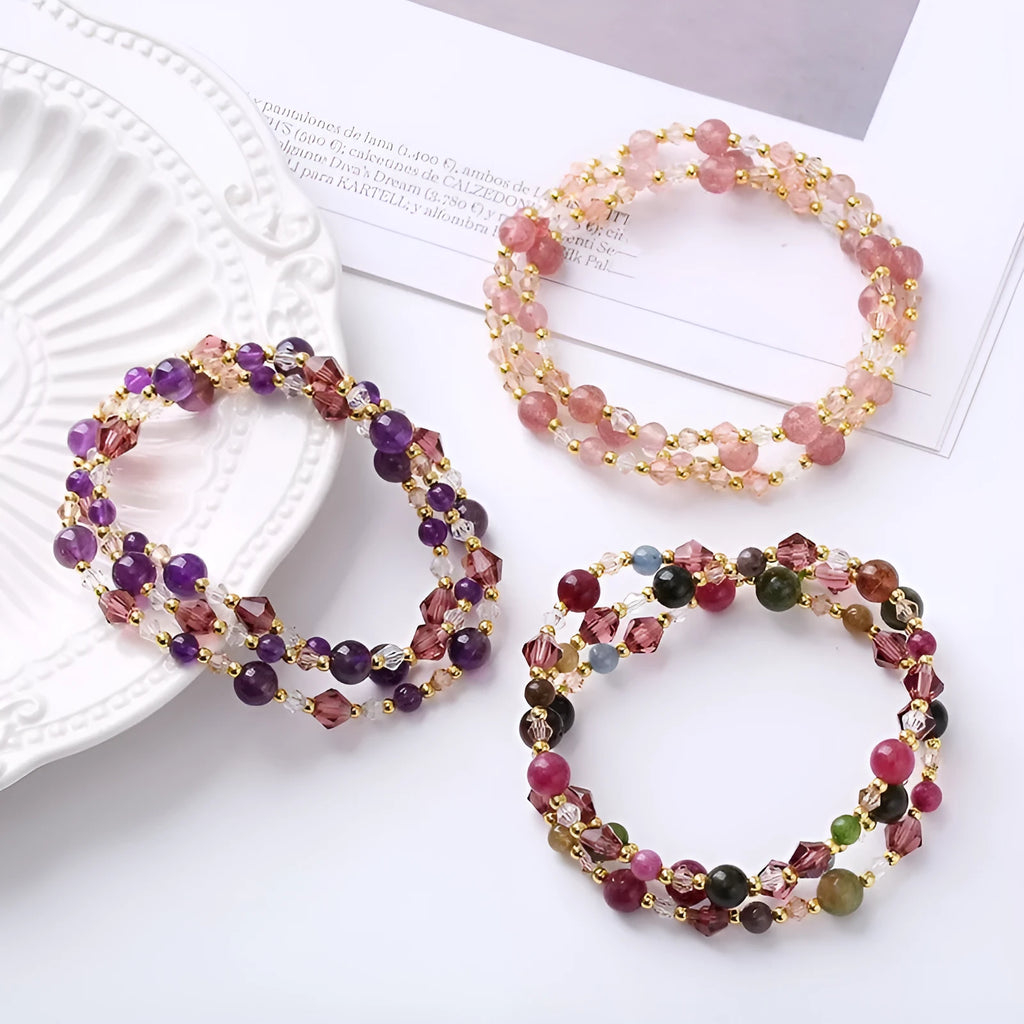 Women's handcrafted three-ring crystal bracelet with tourmaline, strawberry quartz, and amethyst beads on adjustable cord