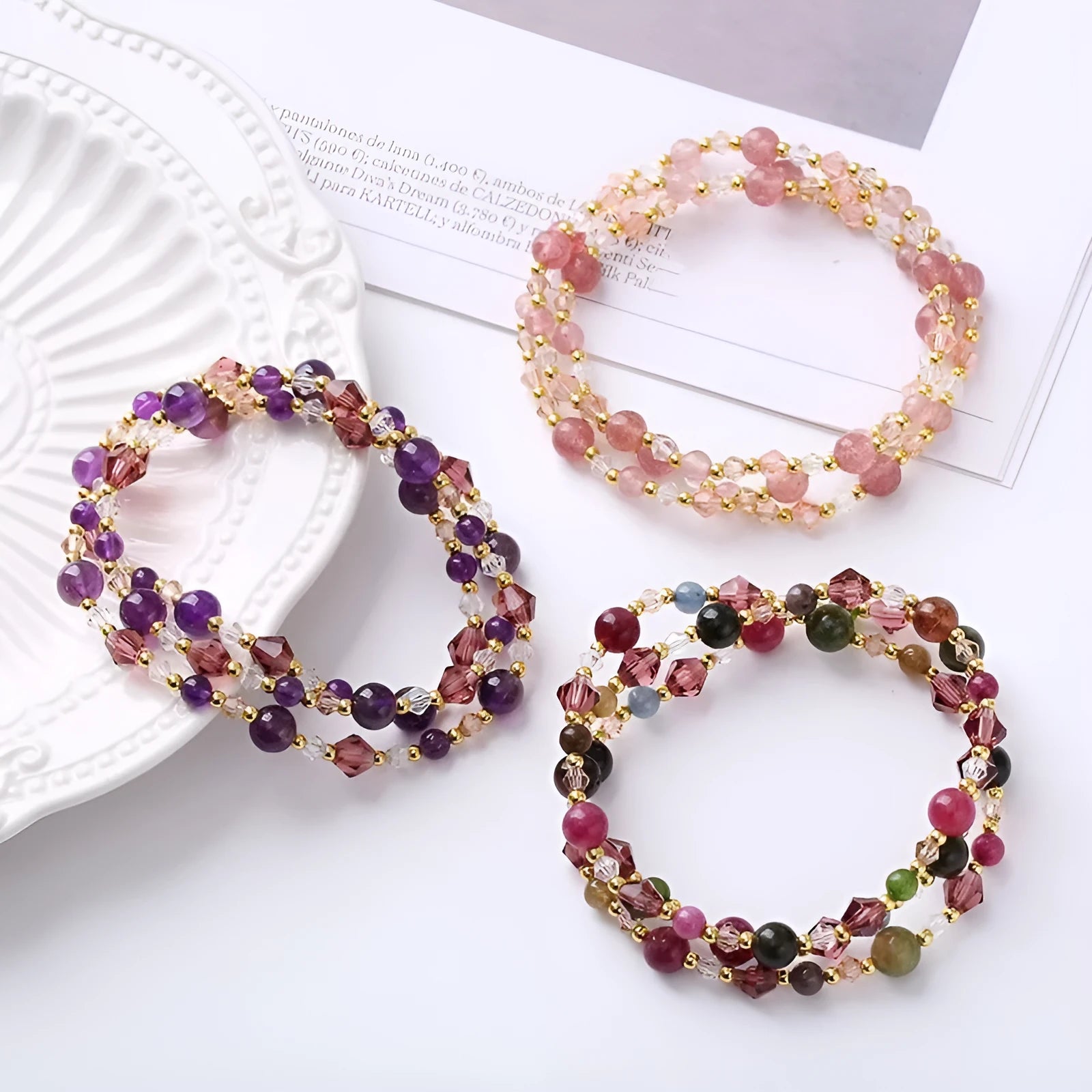 Women's handcrafted three-ring crystal bracelet with tourmaline, strawberry quartz, and amethyst beads on adjustable cord