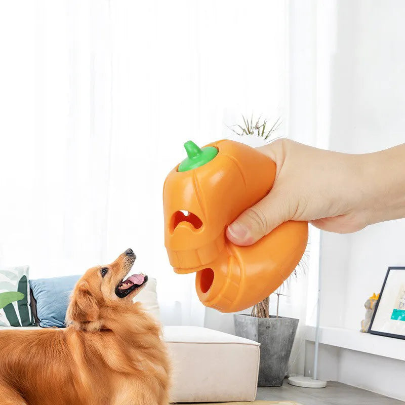 Orange Halloween pumpkin shaped dog chew toy with a treat dispensing funnel.