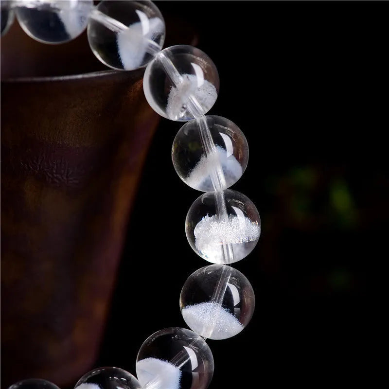 Women's natural white ghost pyramid bracelet with ground crystal beads and Ruyi design element