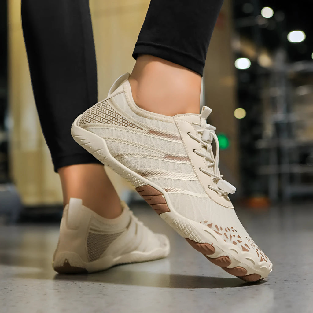 Pair of casual unisex running shoes with Lycra stretch fabric upper, shown in beige colour.