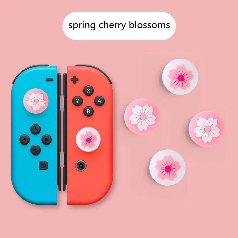 Four silicone rocker caps for Nintendo Switch Joy-Con controllers in assorted colours on a grey background.