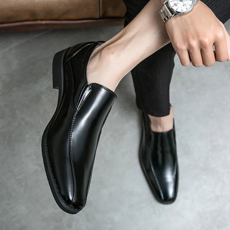 Men's black pointed leather casual shoes with flat rubber sole, shown from side