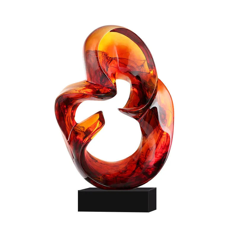 Modern transparent resin craft ornament in orange red and blue colour options on a plain background.
