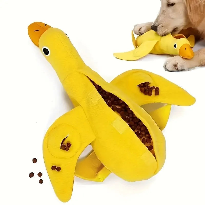 Yellow plush duck dog toy with a sound module and treat-dispensing openings.