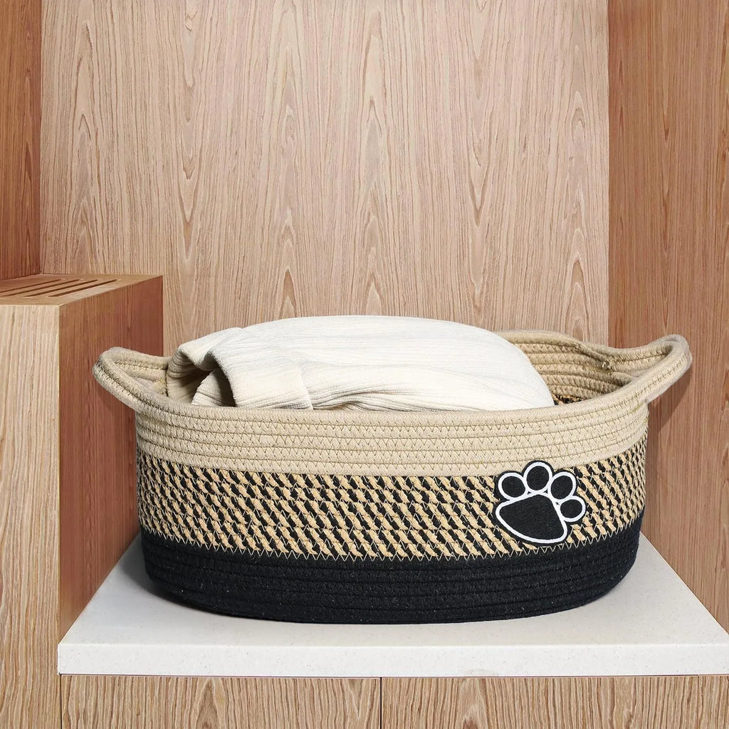 Small light beige handwoven cotton rope storage basket with wooden elements and handle