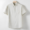 Men's loose-fitting linen-blend lapel t-shirt in black, shown on a model, highlighting the open collar and short sleeves.