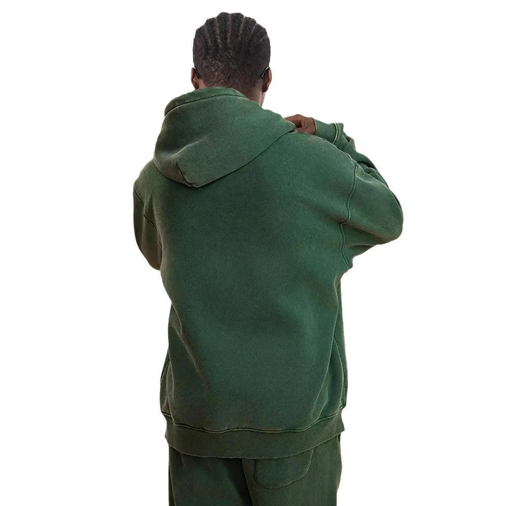 Man wearing a washed black fleece-lined cotton hooded cardigan with a double zipper.