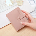 Women's lychee pattern short wallet in beige, pink, black, or red colours with decorative sewing thread detail.