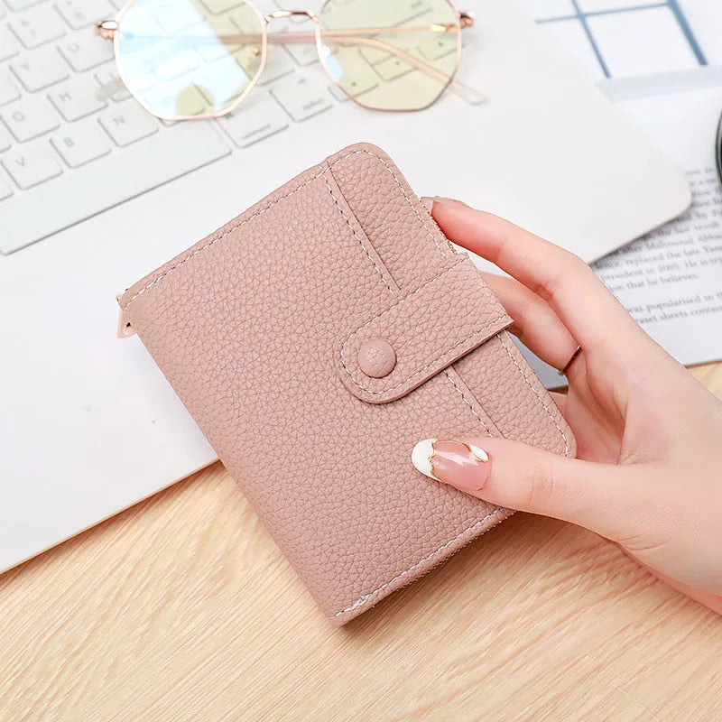 Women's lychee pattern short wallet in beige, pink, black, or red colours with decorative sewing thread detail.