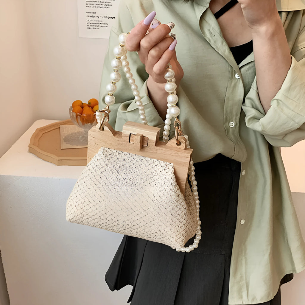 Women's straw woven shoulder bag with pearl chain strap in horizontal square shape showing internal organisers
