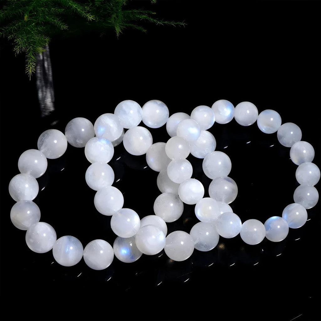 Natural blue moonlight round moonstone bead bracelet on wrist showing polished surface