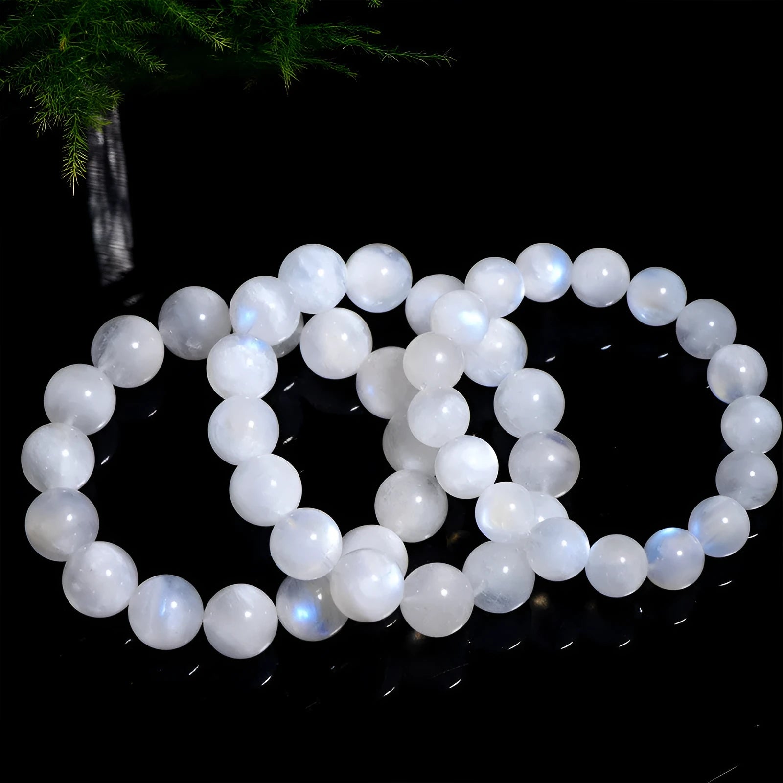Natural blue moonlight round moonstone bead bracelet on wrist showing polished surface