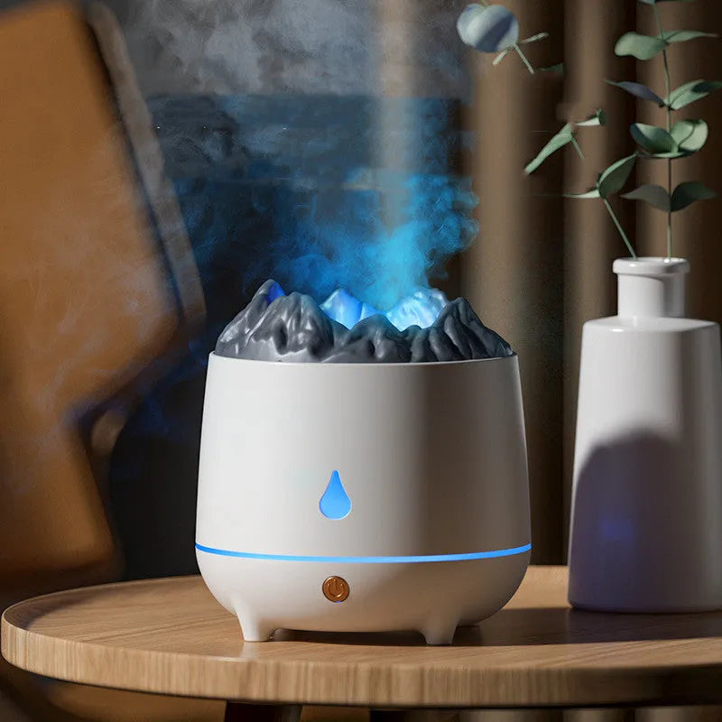 Black volcano-shaped ultrasonic humidifier with USB cable on a wooden table, emitting a plume of mist.