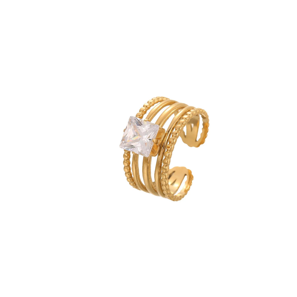 Gold inlaid zircon geometric heart and drop shape stainless steel ring on white background.
