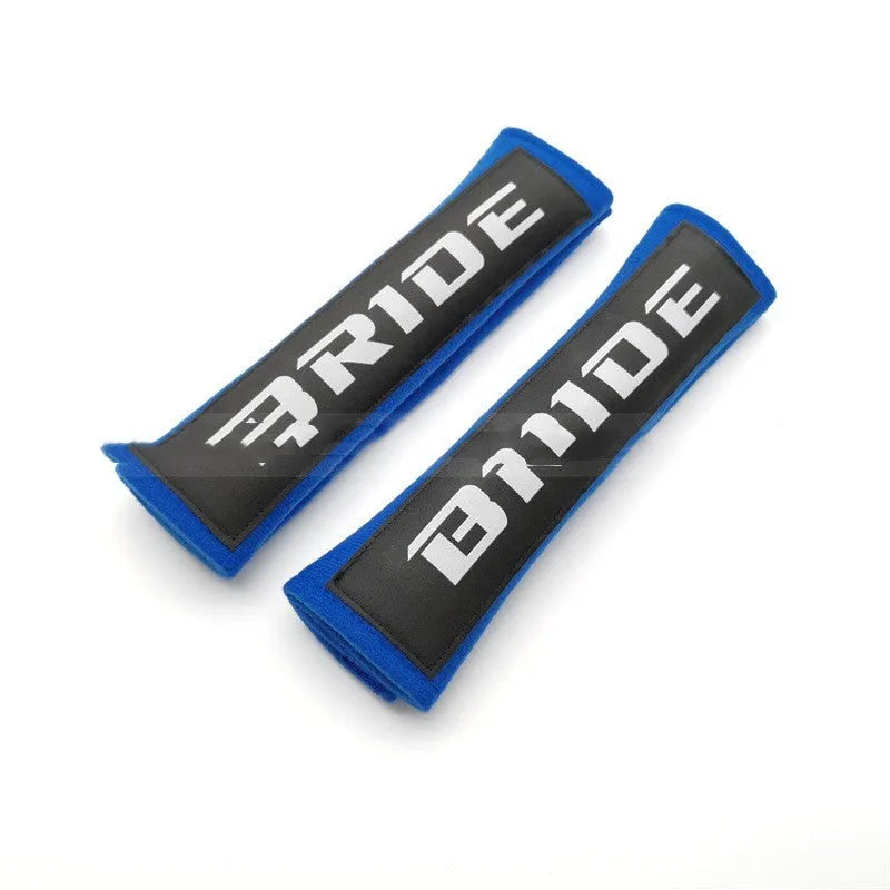 Pair of black car seat belt shoulder pads with embroidery, showing dimensions.